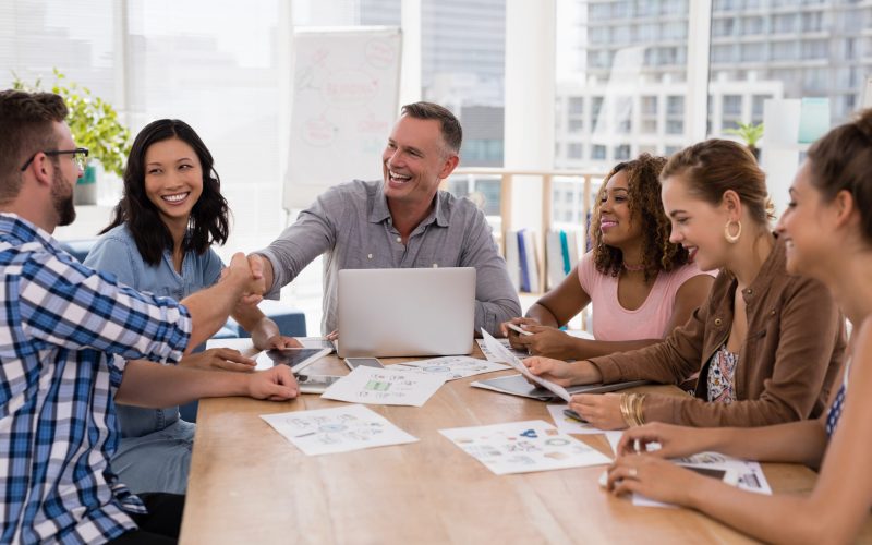 Executives shaking hands in the meeting at office