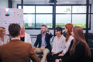 portrait of successful businesswoman using wheelchair while leading business meeting in office with diverse group of people